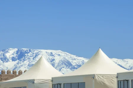 Panoramic Agafay desert luxury camp with Atlas Mountains in background