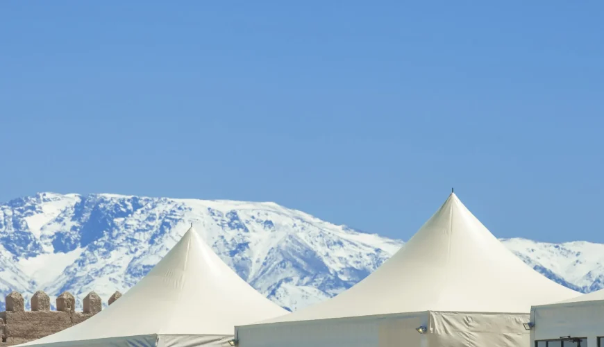 Panoramic Agafay desert luxury camp with Atlas Mountains in background