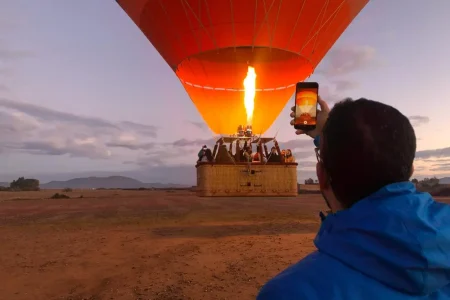 Hot air balloon Marrakech Morocco floating above sunrise desert