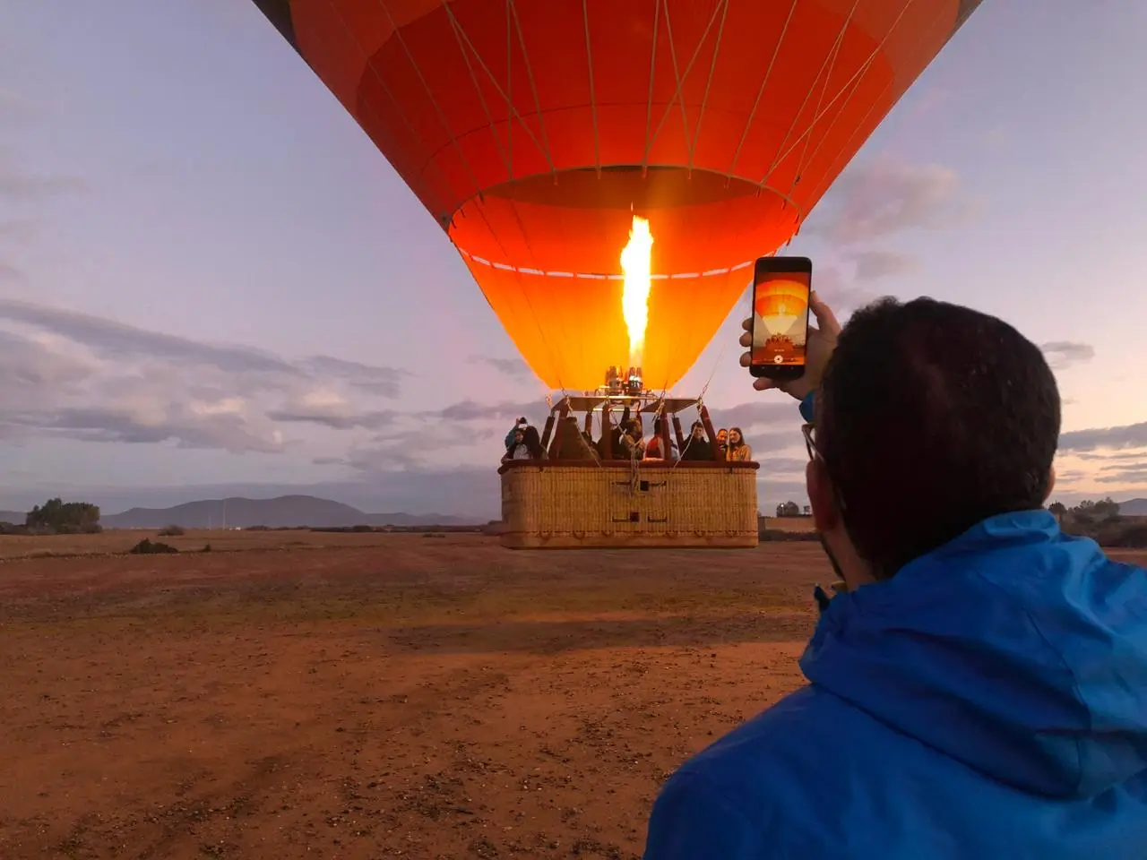 Hot air balloon Marrakech Morocco floating above sunrise desert