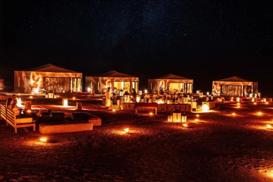 Desert luxury camp Merzouga Morocco at sunset